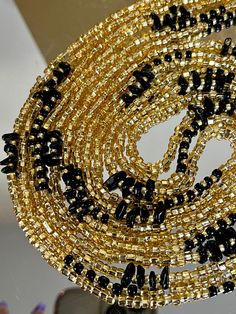 **Please allow up to 5-7 business days for processing time for Waistbeads, Free US Shipping for orders over $75 ** Our stunning Black Love Waistbeads, are perfect for adding a touch of elegance and tradition to your style. These waistbeads feature a beautiful Black and Gold throughout the waistbead. Crafted with high-quality 8/0 and 6/0 glass beads, they offer both durability and beauty. Designed to fit most with a standard length of 60", these traditional tie-on waistbeads allow you to customiz Polished Beaded Bracelets For Party, Elegant Waist Beads With Spacer Beads For Gift, Party Beaded Bracelets With Polished Beads, Black Beaded Necklaces For Wedding, Gift Heishi Beaded Necklaces With Black Beads, Party Polished Round Beaded Bracelets, Oval Beaded Jewelry For Parties, Gold And Black Beads As Gift, Party Beaded Necklaces With Oval Beads