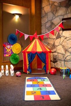 there is a circus tent in the middle of this room with toys on the floor