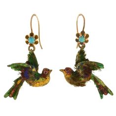 An extremely rare and unusual pair of English earrings from the Victorian (c.1880) era! Each of these artistic earrings is crafted 15kt yellow and carries the shape of an exotic bird. The birds have a 3-dimensional appearance and swing with lovely movement when worn. Both birds are adorned with a bright, colorful enameled surface and delicate ruby eyes. Vibrant shades of green, blue, red enamel give a lively appearance to the design. Undoubtedly, the most unusual aspect of these unique earrings Victorian Gold Earrings, Victorian Earrings Antiques, Victorian Drop Earrings, Turquoise Feather Earrings, Gold Feather Earrings, Artistic Earrings, Earrings Multiple, Antique Gold Earrings, Natural Turquoise Stone