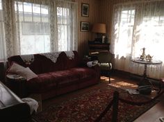 a living room filled with furniture and windows