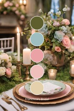 the table is set with candles, plates and flowers in pastel colors on it