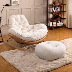 a white chair and ottoman in a living room