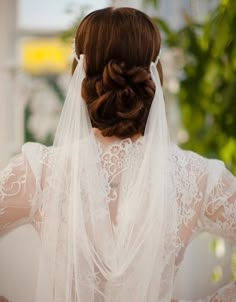 the back of a woman wearing a wedding veil