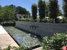 an outdoor water feature in the middle of a garden