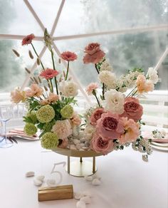 an arrangement of flowers in a vase on a table