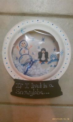 there is a plate with a penguin and snowman on it