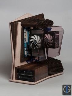 a wooden computer case with two fans on it