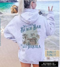 Get ready for the beach vibes with our Wallen Hoodie Sweatshirt, featuring our original Wallen's Beach Bar design inspired by Sand In My Boots. This hoodie is a country music shirt perfect for a concert or a day at the beach. Whether you're a music lover or just love the aesthetic of beach song lyrics, this hoodie is a fantastic choice for both style and comfort. **Also available in Comfort Colors garment dyed tee, see separate listing in our shop SIZING - please read 😊 *This is a 50/50 cotton Cotton Hoodie For Summer Vacation, Summer Vacation Cotton Hoodie, Summer Letter Print Hoodie Sweatshirt, Summer Casual Hoodie With Letter Print, Casual Summer Hoodie With Letter Print, Summer Hoodie Sweatshirt With Letter Print, Hoodie Sweatshirt For Summer Vacation, Casual Beach Hoodie Top, Cotton Hoodie Tops For Vacation