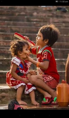 two young children sitting on top of a wooden bench next to each other with a quote in the middle