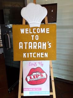 a sign that says welcome to atarah's kitchen with lips on it