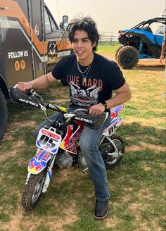 a young man sitting on top of a dirt bike