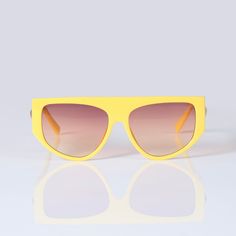 Ebullient adds a vivid pop of color and style to your look. Its eye-catching bright yellow frame, flat top, and gradient lens give you the versatility of a classic pair of shades and enough personality to stand out in any crowd. 100% UVA UVB protection Sizing Front Frame: 152 mm Lens width: 67 mm Bridge: 21 mm Casual Yellow Tinted Aviator Sunglasses, Casual Yellow Aviator Sunglasses With Tinted Lenses, Modern Yellow Cat Eye Sunglasses, Retro Yellow Tinted Aviator Sunglasses, Retro Yellow Aviator Sunglasses With Tinted Lenses, Yellow Tinted Plastic Sunglasses, Yellow Shield Sunglasses With Uv Protection For Summer, Yellow Tinted Aviator Sunglasses For Summer, Trendy Yellow Mirrored Shield Sunglasses