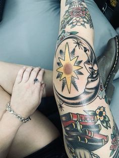 a woman with tattoos on her leg and arm