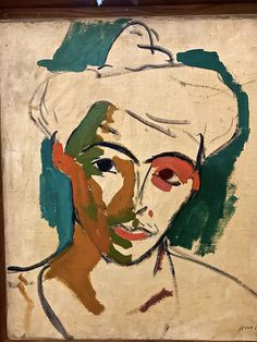 a painting of a woman wearing a white hat with green and orange paint on her face