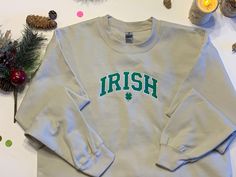 This is a sweat shirt with an embroidered design of Irish in green on it. Available in sizes small to X-Large sweatshirts. Colors available are sand, pink, sport grey, heathered red, and heathered maroon. We have a wide range of other images available, along with other colored shirts. Please send us a massage to inquire about the other options. These items are machine embroidered. They  are made in Amarillo,Tx. Because they are done individually there may be slight variations to the items. Casual Green Sweater With Embroidered Graphics, Green Crew Neck Sweatshirt With Embroidered Text, Fall Heather Sweatshirt For Streetwear, Gray Casual Sweatshirt With Embroidered Logo, Heather Color Sweatshirt For Fall Streetwear, Green Casual Sweatshirt With Embroidered Text, Casual Gray Sweatshirt With Embroidered Logo, Casual Green Sweatshirt With Embroidered Text, Casual Green Sweatshirt With Embroidered Graphics