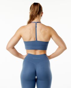 HIGHLIGHTS. Brushed on inside and outside. Mid chest front neckline style. High waistband. Adjustable straps. Moisture-wicking fabric. Alphalete core wordmark logo in tonal raised silicone. Longline. Medium to low impact and includes removable cups FIT SUGGESTION. This item runs true to Alphalete’s standard fit.. If you are between sizes, we recommend sizing up for a relaxed fit and down for a body-con fit. Model is 5’5”/165cm, wearing a size S with a 32”/81cm bust. MATERIALS AND WASHING DIRECTI Solid Recycled Polyester Sports Bra For Training, Solid Color Recycled Polyester Sports Bra For Training, Solid Activewear With Adjustable Straps For Training, Blue Compressive Nylon Sports Bra, Micro-elastic Blue Sports Bra For Sports, Blue Sports Bra With Light Support And 4-way Stretch, Blue Sports Bra With 4-way Stretch And Light Support, Blue Seamless Nylon Sports Bra, Blue Sports Bra With Adjustable Straps For Gym