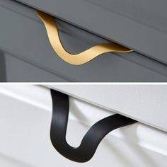 the handles on two drawers are gold and black, while the bottom one is white