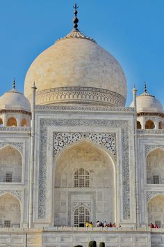 an ornate white building with many windows and arches