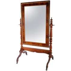 an ornate wooden mirror on stand against a white background