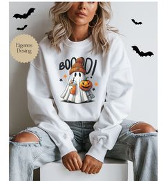 Cute Ghost Halloween Sweatshirt - The perfect cozy spooky look! Add a playful and cozy touch to your Halloween wardrobe with our cute Ghost Halloween Sweatshirt! This high-quality, comfortable sweatshirt is made from soft, breathable fabric that will keep you warm while you celebrate the spooky season in style. The charming ghost design is guaranteed to make you and your friends smile and provide plenty of Halloween fun. Whether you're attending a Halloween party, trick-or-treating, or just want Spooky Halloween Crew Neck Sweater, White Graphic Print Sweatshirt For Halloween, White Long Sleeve Halloween Sweatshirt, Halloween Cartoon Print Long Sleeve Sweatshirt, White Crew Neck Sweater For Halloween, Casual White Sweatshirt For Halloween, Casual White Sweater For Halloween, White Cartoon Print Sweater For Fall, Fun Halloween Crew Neck Sweatshirt