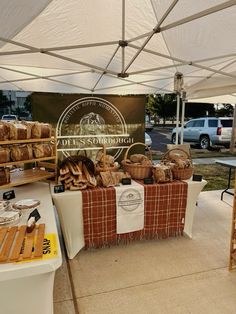 a table with bread on it under a tent