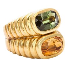 Chunky, deeply ridged concentric ovals rise from the finger to show the proud colors of green and gold set at their pinnacle. The stones, a tourmaline and a citrine are rounded rectangles, clear and color saturated. This ring, a dashing fashion statement, was executed in 18kt deep yellow gold. Made c. 1960. For the bold in fashion. Weight 27.3 grams. Size 6 Your fine jeweler can make the ring fit you perfectly. Plenty of gold to enlarge the shank. 1970s Jewelry, Green Tourmaline Ring, Tourmaline Ring, Fine Jewels, Antique Diamond, Ring Fit, Green Tourmaline, Gold Set, Diamond Gemstone