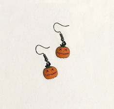 "Orange Jack O'Lantern Earrings These are alloy metal orange Jack O'Lantern earrings coated with orange enamel and black detailing (the back is black). The dangle ear wires are a gunmetal color (lead and nickel free). Comes delivered to you on a card and in a pretty organza bag, perfect for gift-giving.  Quantity: 1 Pair  Material:  Zinc Metal Alloy (Lead Free & Nickel Free) & Enamel  Size: (Approximate) Pumpkin: 1/2\"  Color:  Orange, Black & Gunmetal FREE SHIPPING on purchases of $35 or more! If you need a larger quantity, please let me know. ms23 TAKING CARE OF ZINC ALLOY JEWELRY Your Zinc Alloy Jewelry may tarnish if exposed to water (and sometimes to skin products). Take the jewelry off before you bathe or swim, and store the jewelry in a clean, dry area." Cheap Orange Spooky Earrings, Bag Of Gold, Lantern Earrings, Elephant Earrings, Bird Skull, Green Opal, Skull Earrings, Halloween Jewelry, Gothic Jewelry