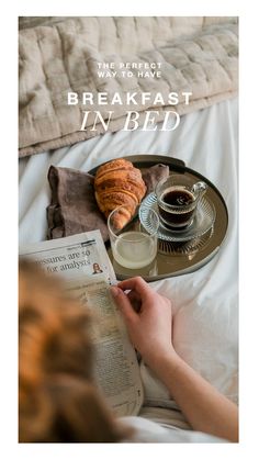 breakfast in bed with coffee and croissants on the tray next to it