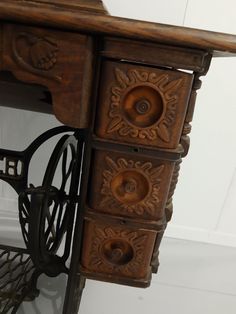 an antique sewing machine with wooden drawers