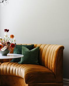 a living room with a couch, table and flowers