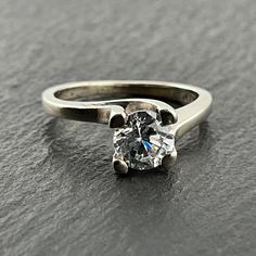 a close up of a ring with a diamond on the top and bottom part of it