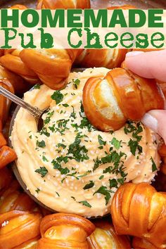 someone dipping some food into a bowl with cheese and herbs on top, in front of the words homemade pull - out cheese