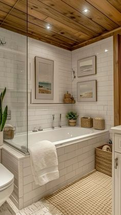 a bathroom with white tile and wooden ceiling