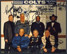 an autographed photo of the baltimore colts team in front of a wall with signed autographs