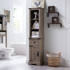 a bathroom with white walls and flooring has a wooden cabinet next to the toilet