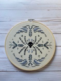 a white and black embroidery on a wooden surface