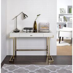 a white desk with a lamp and books on it