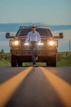 a man standing in front of a truck on the road