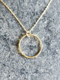 "This beautiful necklace has a handmade tiny gold circle. Perfect to wear every day. The circle measures 10mm across and it hangs on a 14K gold filled chain with a 14K gold filled clasp. Shown in 18\" length, but can be made as a long layering necklace also. Please choose length above. Also available in silver as shown in the last photo. *If you are unsure of the length you need, or would like to wear this item at different lengths, we now offer an adjustable length option! You can add an adjust Everyday Yellow Gold Circle Charm Necklace, Circle Shaped Yellow Gold Charm Necklace For Gift, Circle Charm Necklace In Yellow Gold For Gift, Yellow Gold Circle Charm Necklace For Gift, Gold Circle Minimalist Charm Necklace, Minimalist Circle Charm Gold Necklace, Simple Circular Yellow Gold Jewelry, Minimalist Gold Circle Charm Necklace, Minimalist Yellow Gold Round Charm Necklace