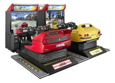 two video game machines sitting next to each other on top of a black platform with yellow and red cars