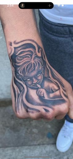 a person with a tattoo on their hand