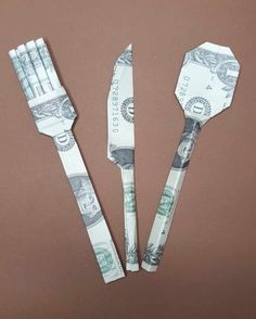 three forks and two knives made out of dollar bills