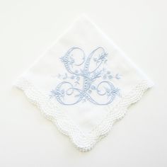 a white handkerchief with blue embroidery on it