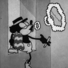 an animated mickey mouse with a wreath on the wall