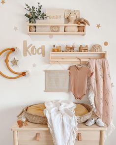 a baby's room is decorated in neutrals and pastel tones with stars on the wall