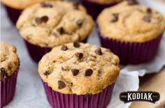 chocolate chip muffins sitting on top of a wooden table