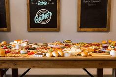 a wooden table topped with lots of different types of foods and condiments on top of it