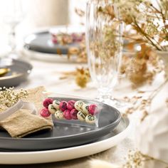 the table is set with plates, silverware and napkins for dessert or appetizers