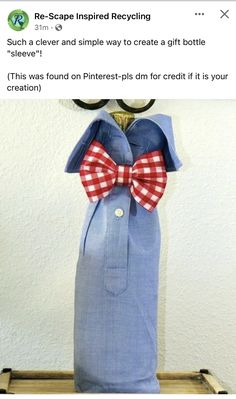 a blue bag with a red and white bow tie hanging from it's side