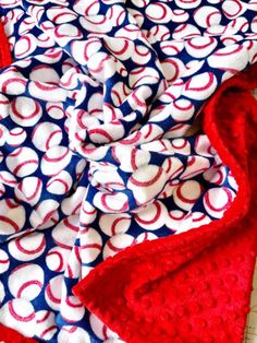 a red, white and blue blanket laying on top of a table